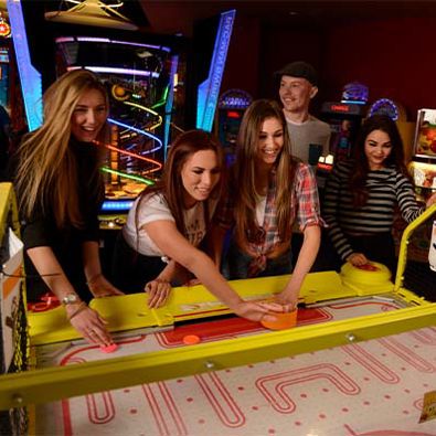 Group of friends playing air hockey