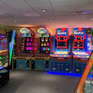 Arcade machines lining the walls, each glowing with vibrant colors, inviting players to experience a world of gaming
