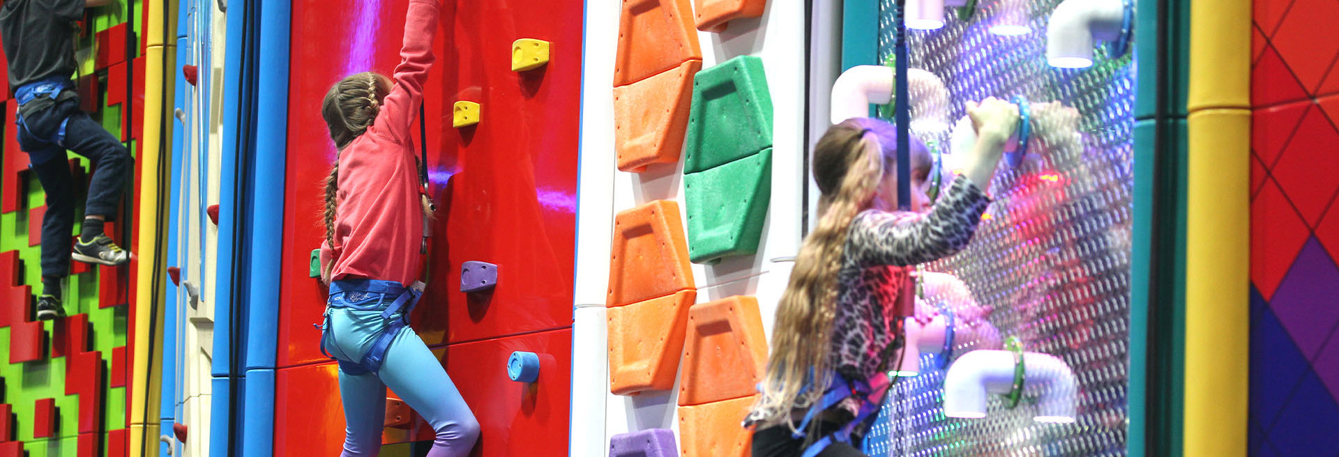 Group of children climbing on clip n climb walls
