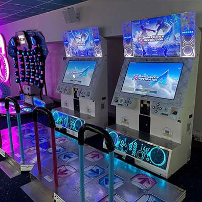 A Dance Dance Revolution machine with colorful arrows on the floor, inviting players to dance and step to the beat