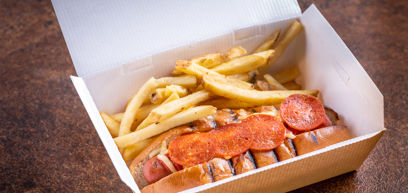 Loaded Pizza Dog and fries in takeaway box