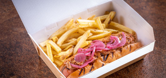Pulled Pork Dog with chips in a takeaway box