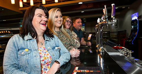 Group of women smiling by the bar
