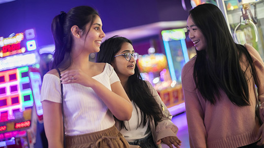 Group of girls walking and socialising in arcade