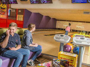 Group of kids playing bowling and having a good time