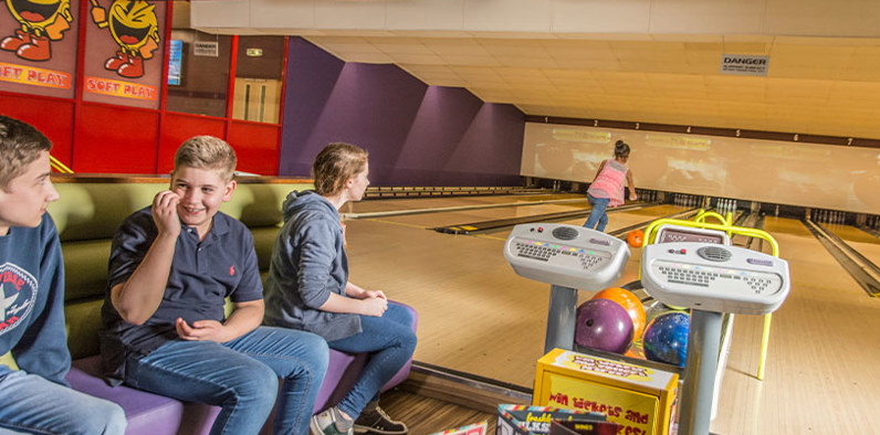 Group of kids playing bowling and having a good time
