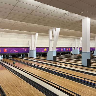 Multiple bowling lanes awaiting the strike of a bowling ball