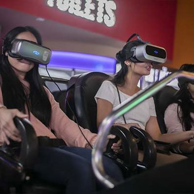 Two girls wearing virtual reality headsets