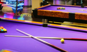 A group of purple pool tables