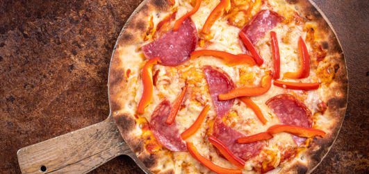 Pepperoni, with Bell peppers, Cheddar, Mozzarella, tomato sauce and rocket  served on a pizza plate