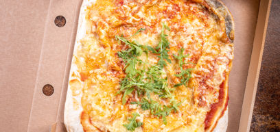 Margherita pizza with Cheddar, Mozzarella, tomato sauce and rocket  in a pizza box