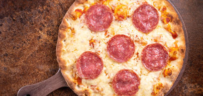Pepperoni, Cheddar, Mozzarella, tomato sauce and rocket on pizza plate