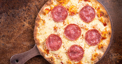Pepperoni, Cheddar, Mozzarella, tomato sauce and rocket on pizza plate