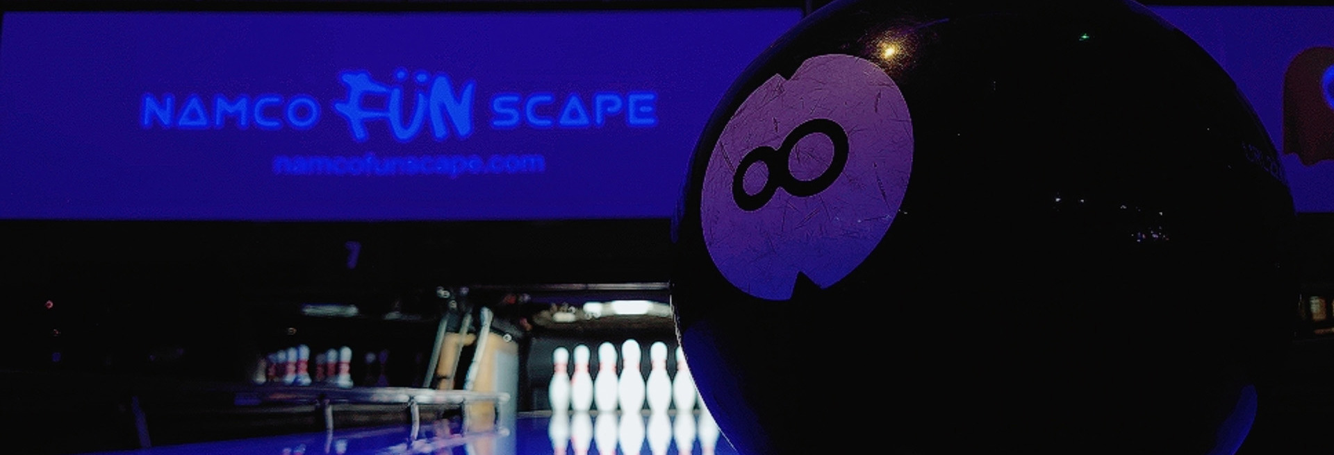 Lucky number eight bowling ball in front of bowling lane