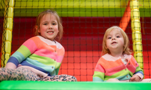 Two young girls playing girls playing in soft play at namco funscape