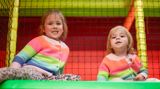 Two young girls playing girls playing in soft play at namco funscape